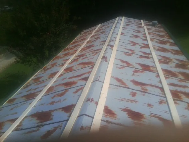 Rusted metal roof panels with new wood purlins before replacement — Storm Damage Roof Repair in Mico by Roofing Brothers